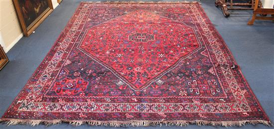 Shiraz red ground carpet, 10ft by 7ft 5in.(-)